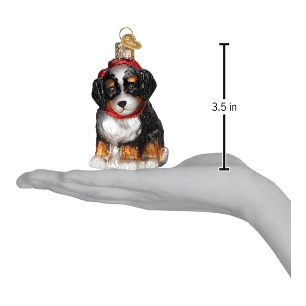 Glass ornament of a dog with measurement on a hand on a white backround.