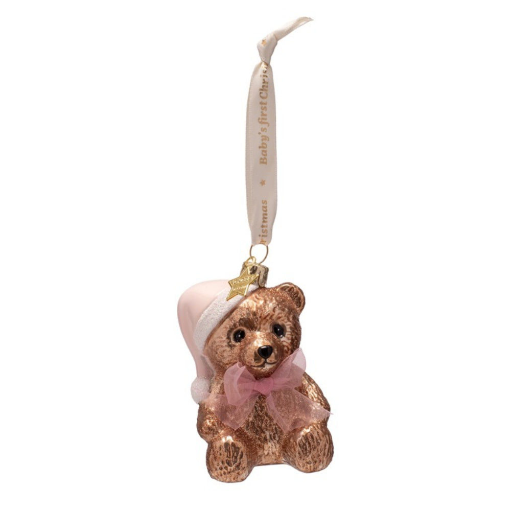 Decorative bear ornament with pink bow and baby hat on a white background