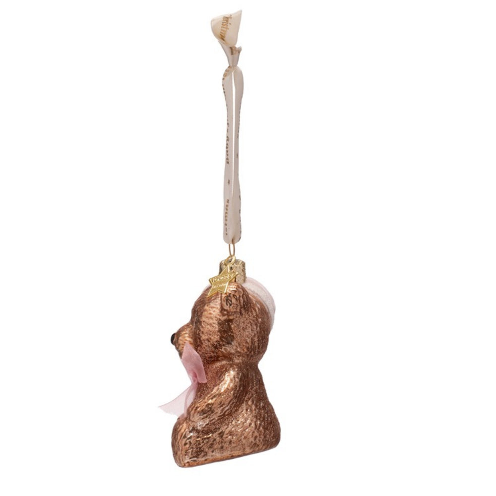 Decorative bear ornament with a pink bow on a white background