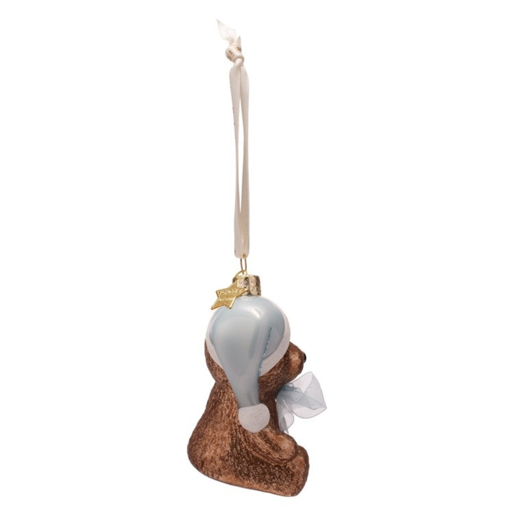 Decorative bear ornament with a white ribbon on a white background