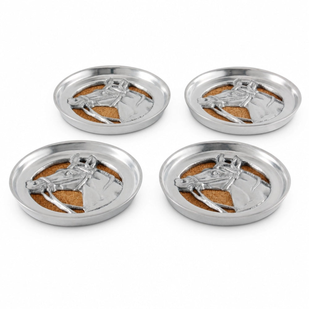 Four round silver metal coasters arranged in a 2x2 grid on a white background. Each coaster features a raised silver horse head design over a tan cork insert.