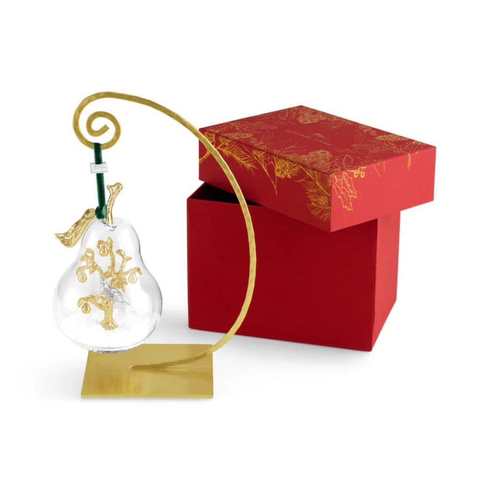 Decorative item with gold accents on a stand next to a red box with gold designs.