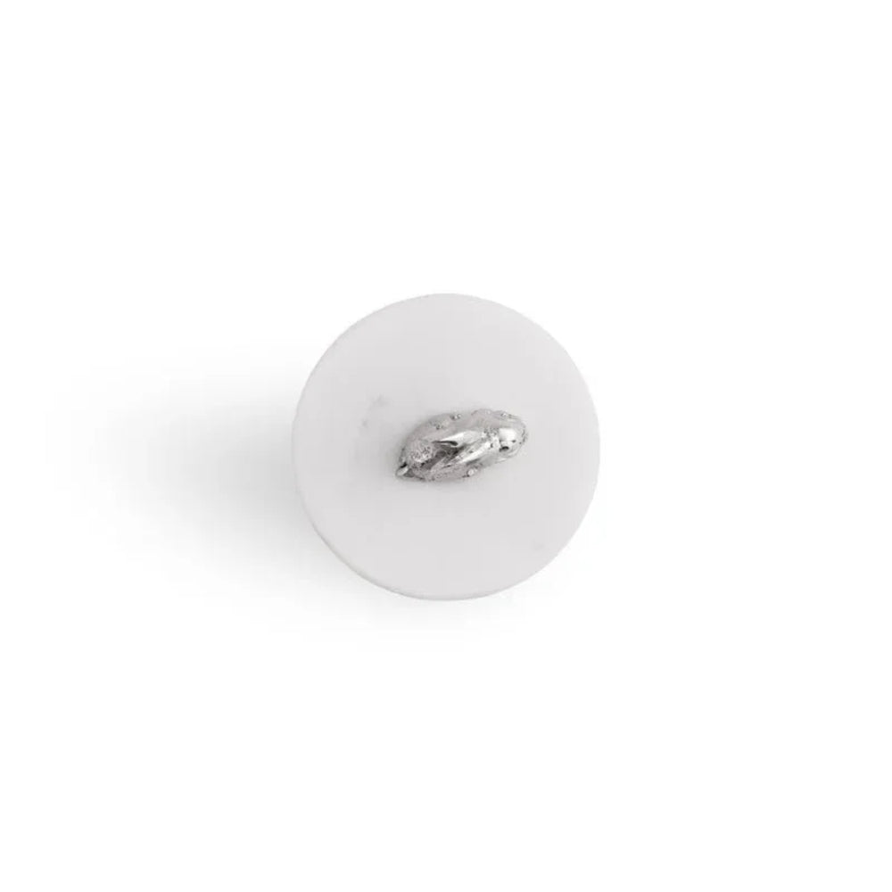White button with a silver brooch on a white background