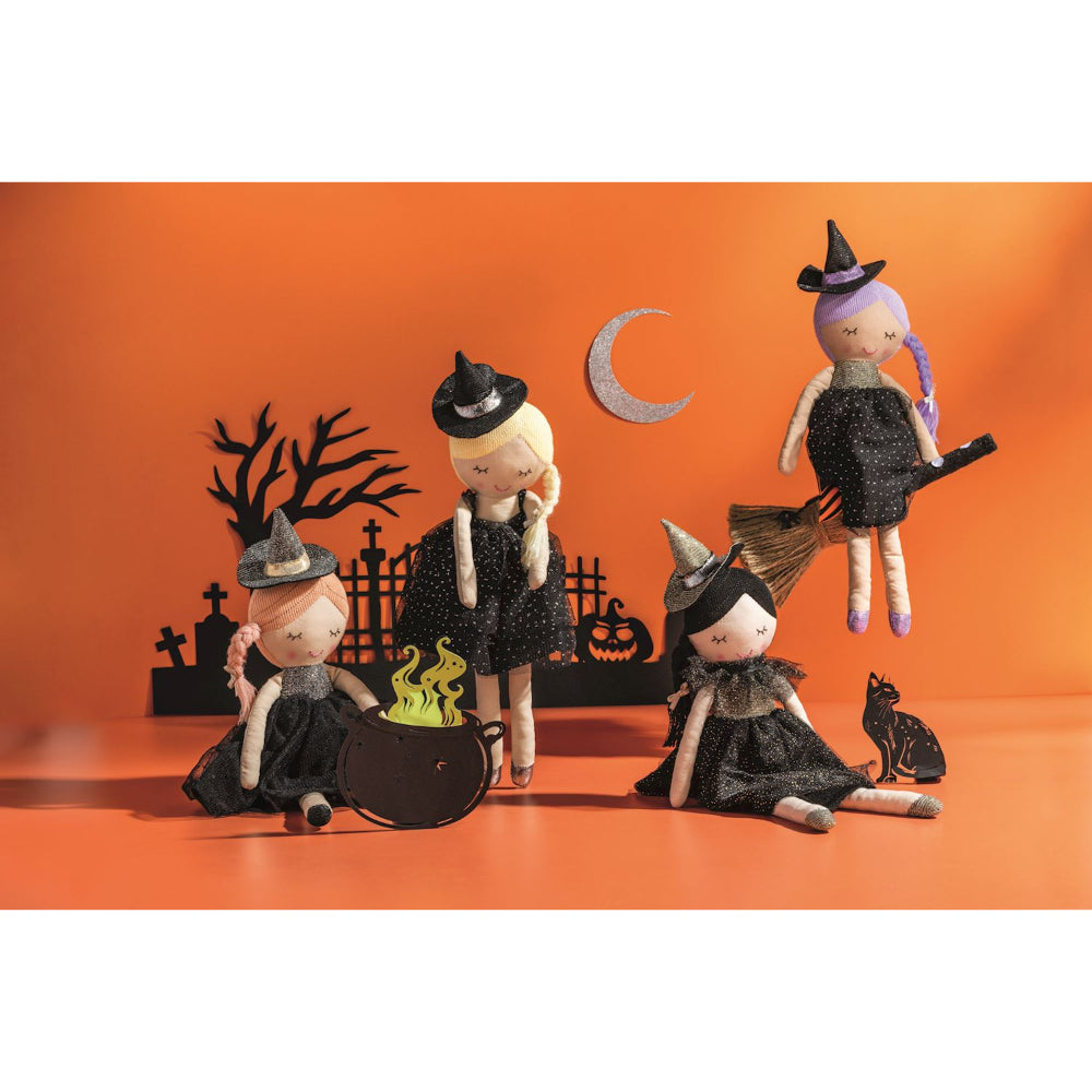 Halloween-themed dolls with witch costumes on an orange background.