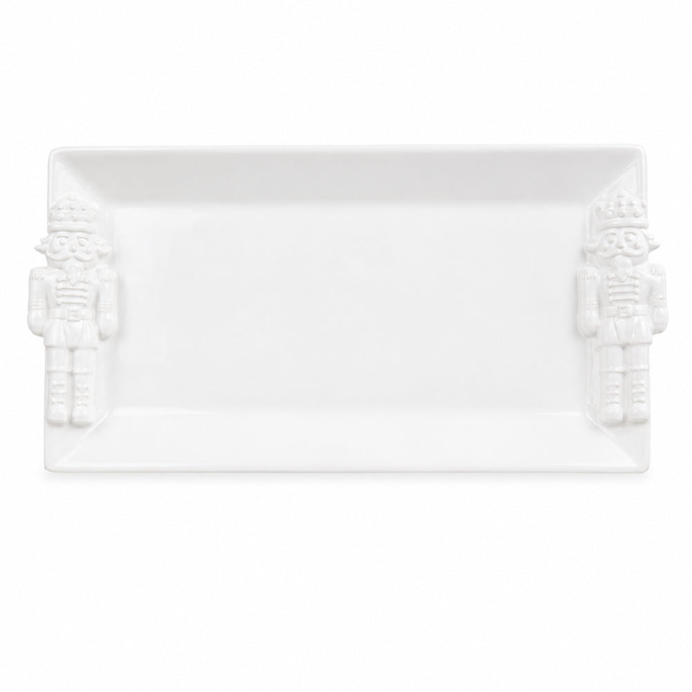 A white rectangular ceramic serving platter with embossed nutcracker figures on both short ends, shown against a plain white background.