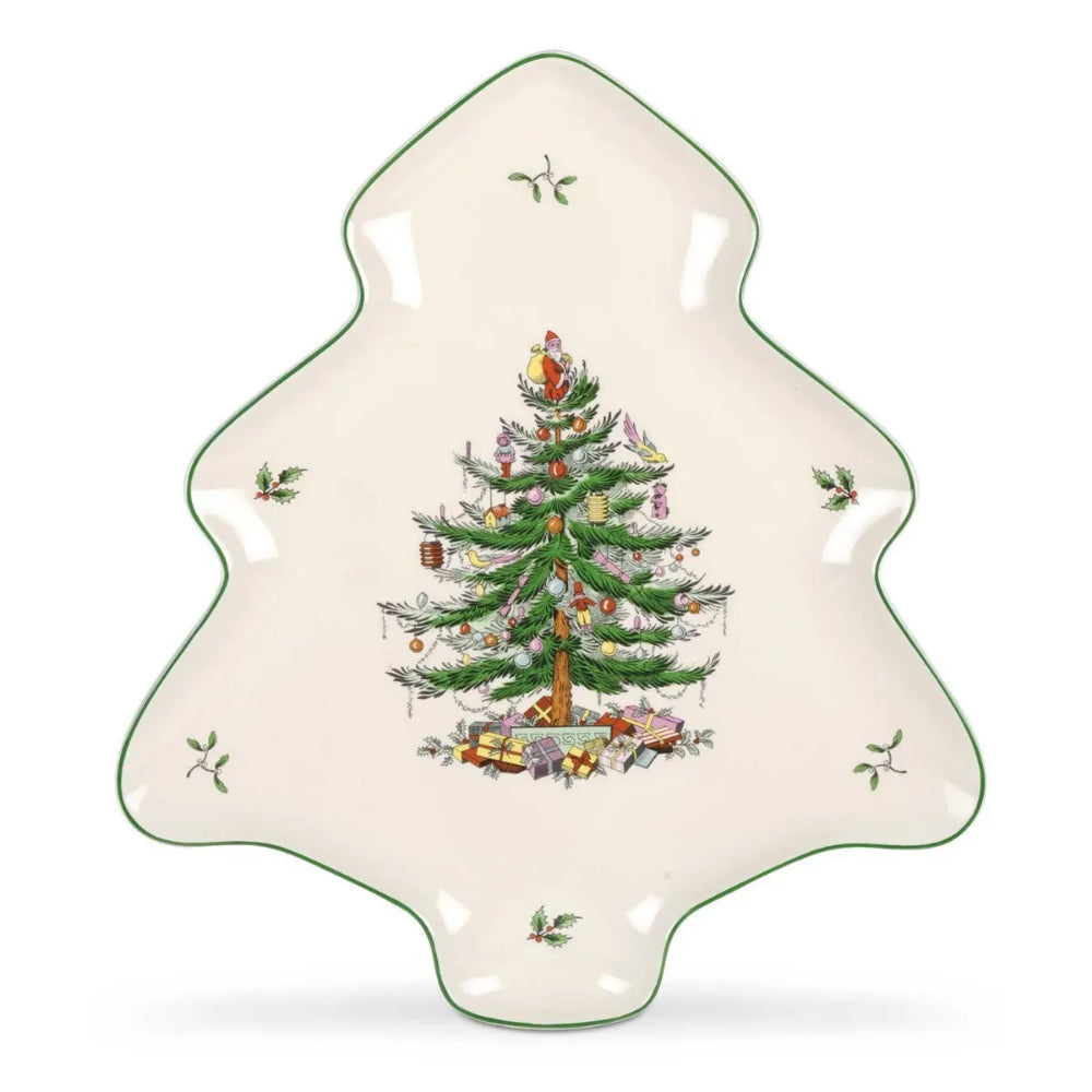 A Christmas tree-shaped ceramic serving platter with a green rim and a central illustration of a decorated Christmas tree, set against a plain white background.
