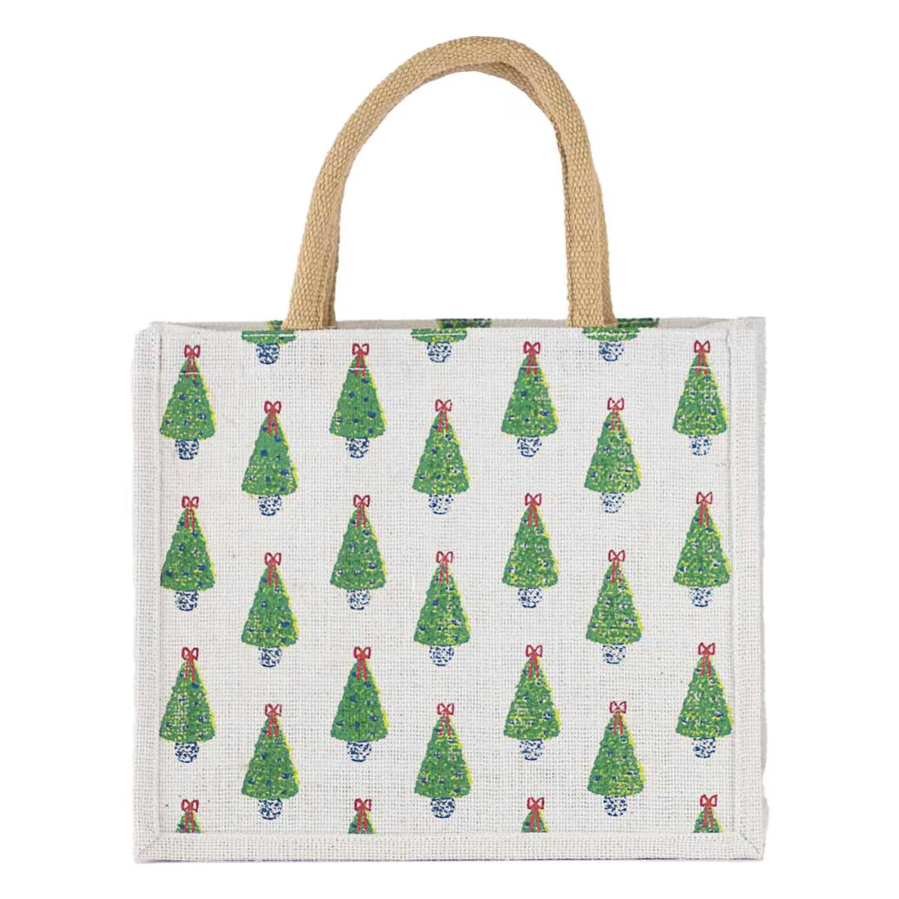 A canvas tote bag with a natural beige jute handle, featuring a repeating pattern of green Christmas trees with red bows and blue ornaments on a white background.