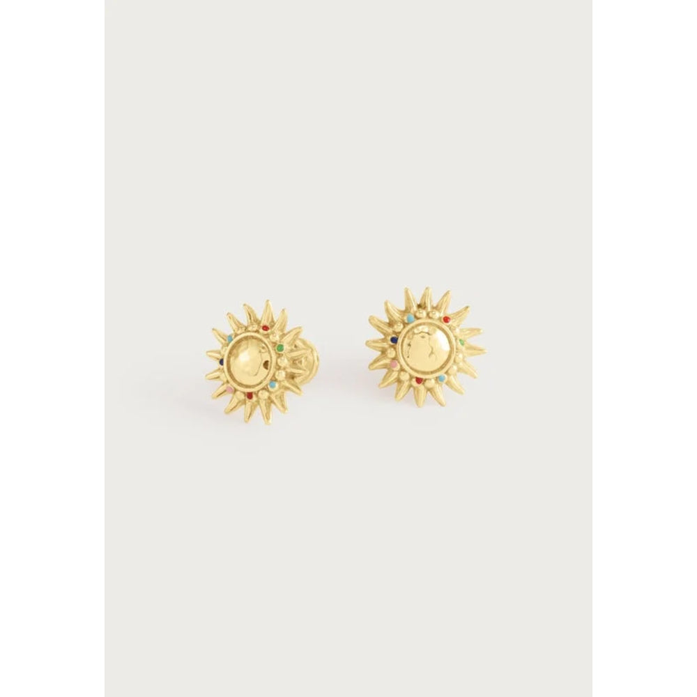 A pair of gold sunburst stud earrings with small colorful gemstone accents, displayed on a light gray background.