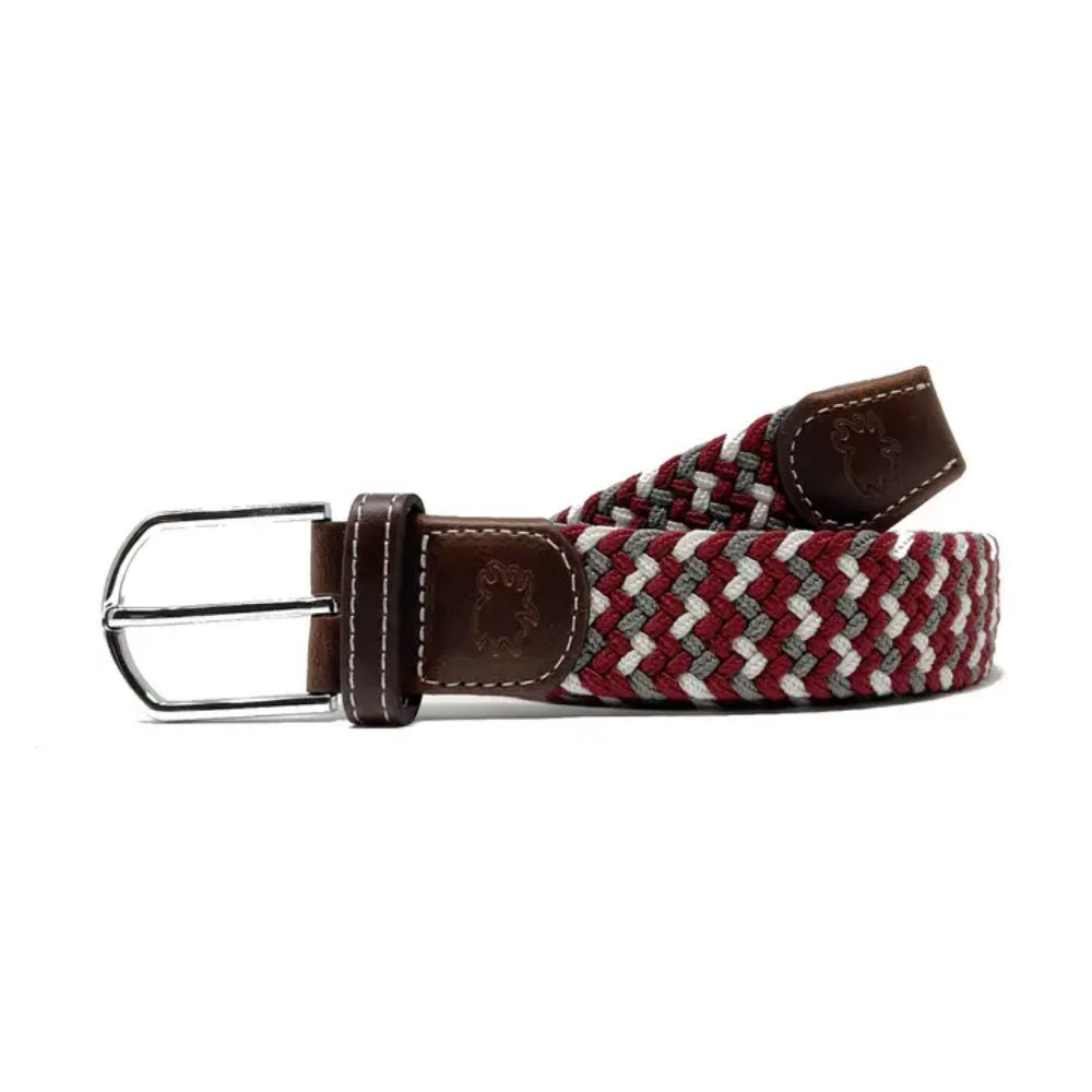 Woven belt with brown leather ends and buckle on a white background