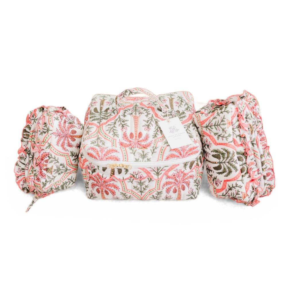Set of 3 multi-color quilted cosmetic bags on a white background