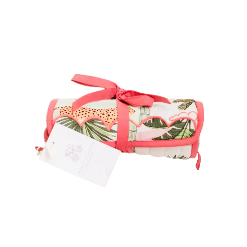 Pink and green quilted design jewelry roll on a white background