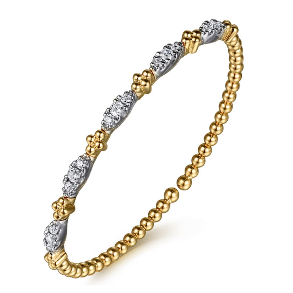 Gold and silver beaded bracelet on a white background