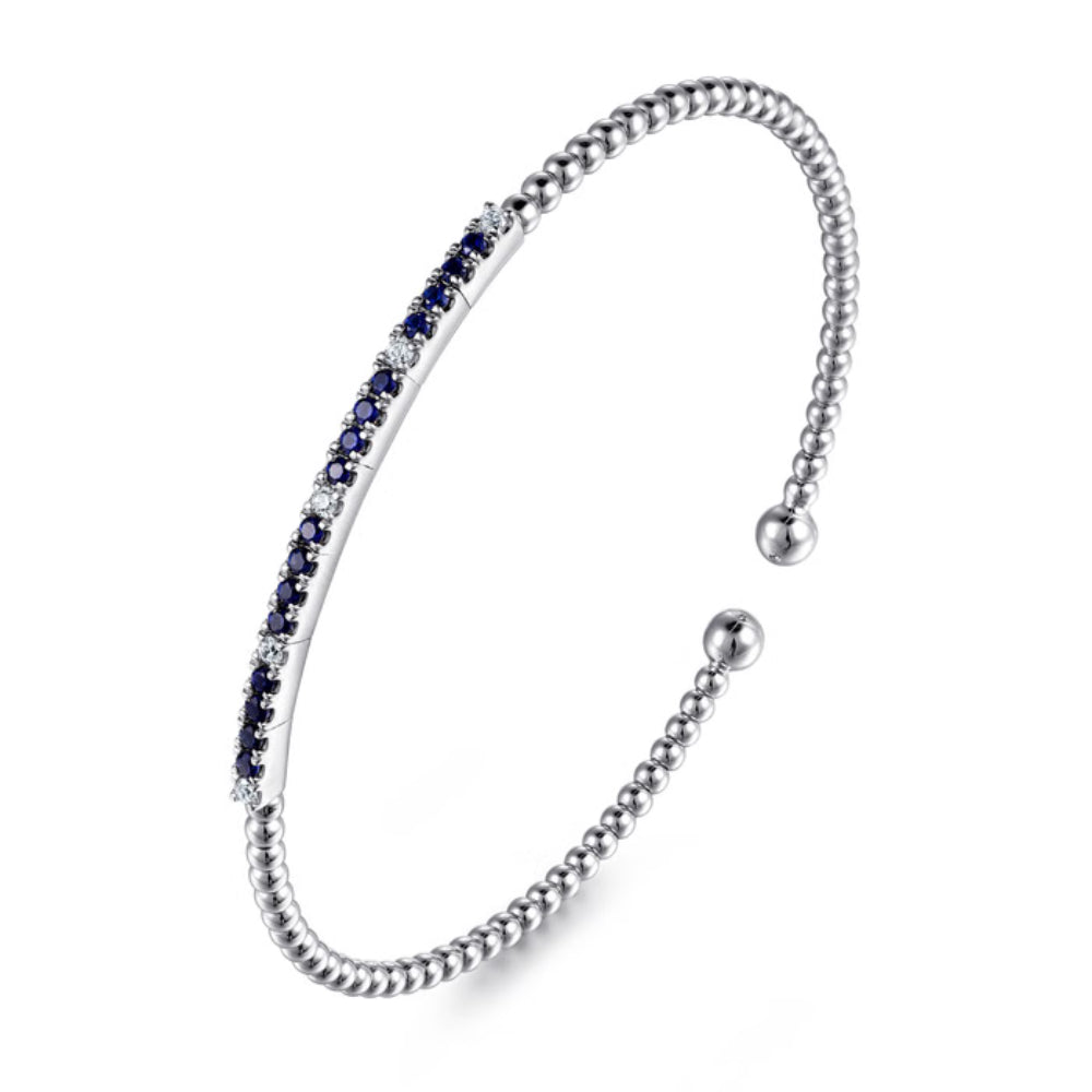 Silver bracelet with blue stones on a white background
