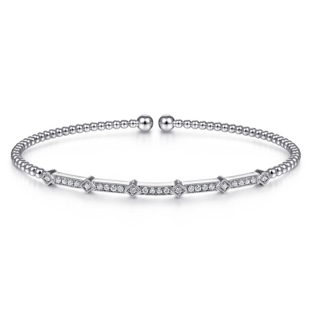A silver beaded bangle bracelet with a central bar set with small clear stones, displayed on a clean white background.