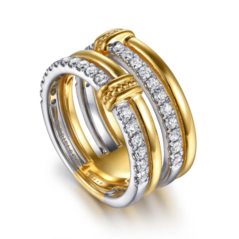 A two-tone gold and silver ring with multiple interlocking bands, some adorned with rows of clear pavé stones, shown on a clean white background.