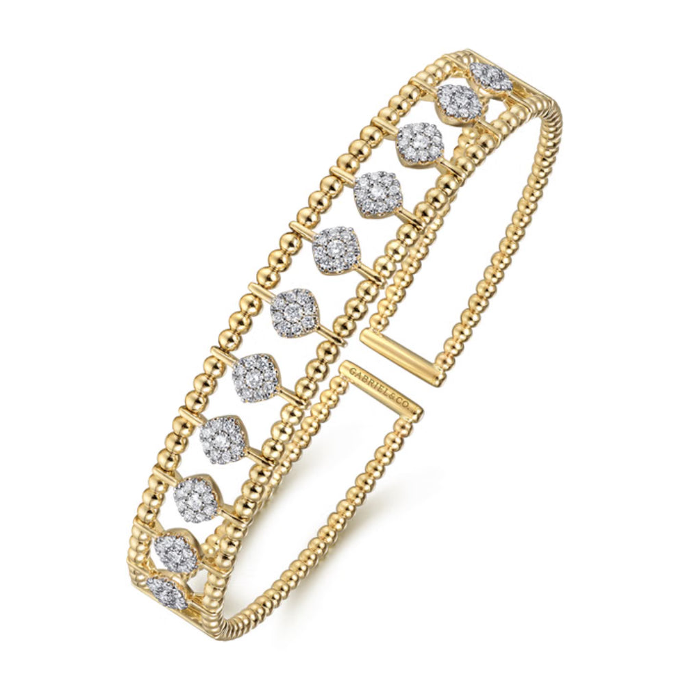 A yellow gold double-strand bangle bracelet featuring rows of round-cut and square-cut clear gemstones, displayed on a clean white background.