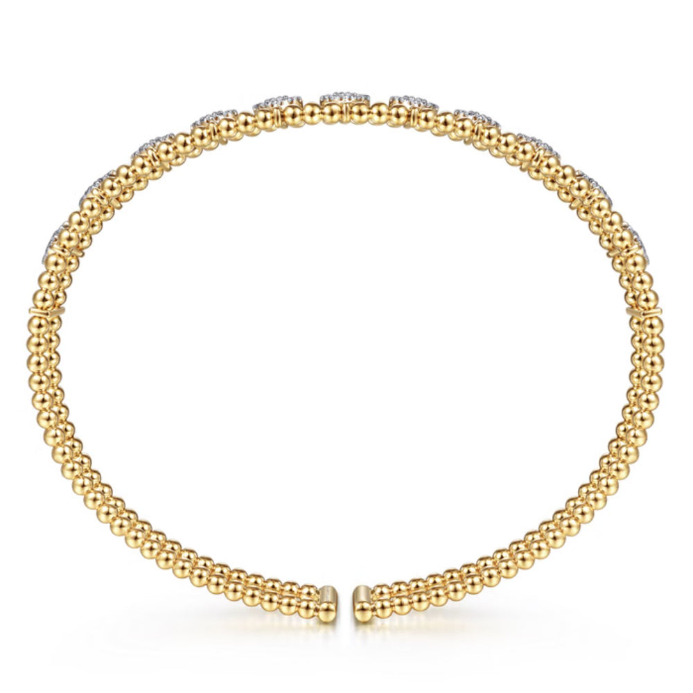 A gold beaded stretch bracelet with a clasp closure, displayed on a clean white background.