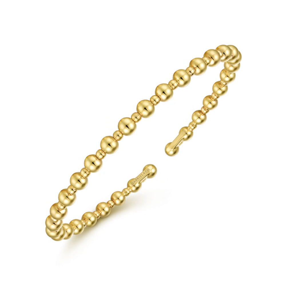 A gold beaded open cuff bracelet with a polished finish and a spring-ring clasp, shown on a clean white background.