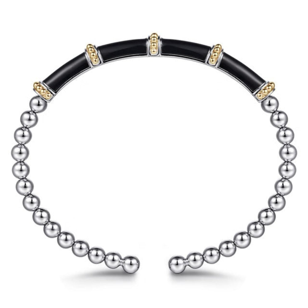 A split-design bangle bracelet featuring black enamel  band accented with small gold details, and a silver beaded chain wrapping around the outer sides, 