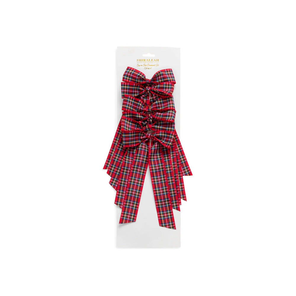 A red and green plaid ribbon bow with long tails, presented on a white retail card against a plain white background.