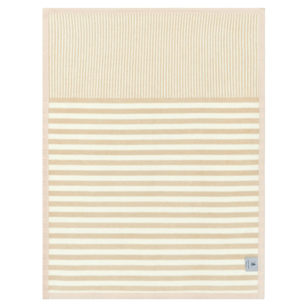 A rectangular baby blanket with a striped pattern in cream and light beige, featuring a solid cream top section and horizontal stripes below. A small fabric tag is visible in the bottom right corner.