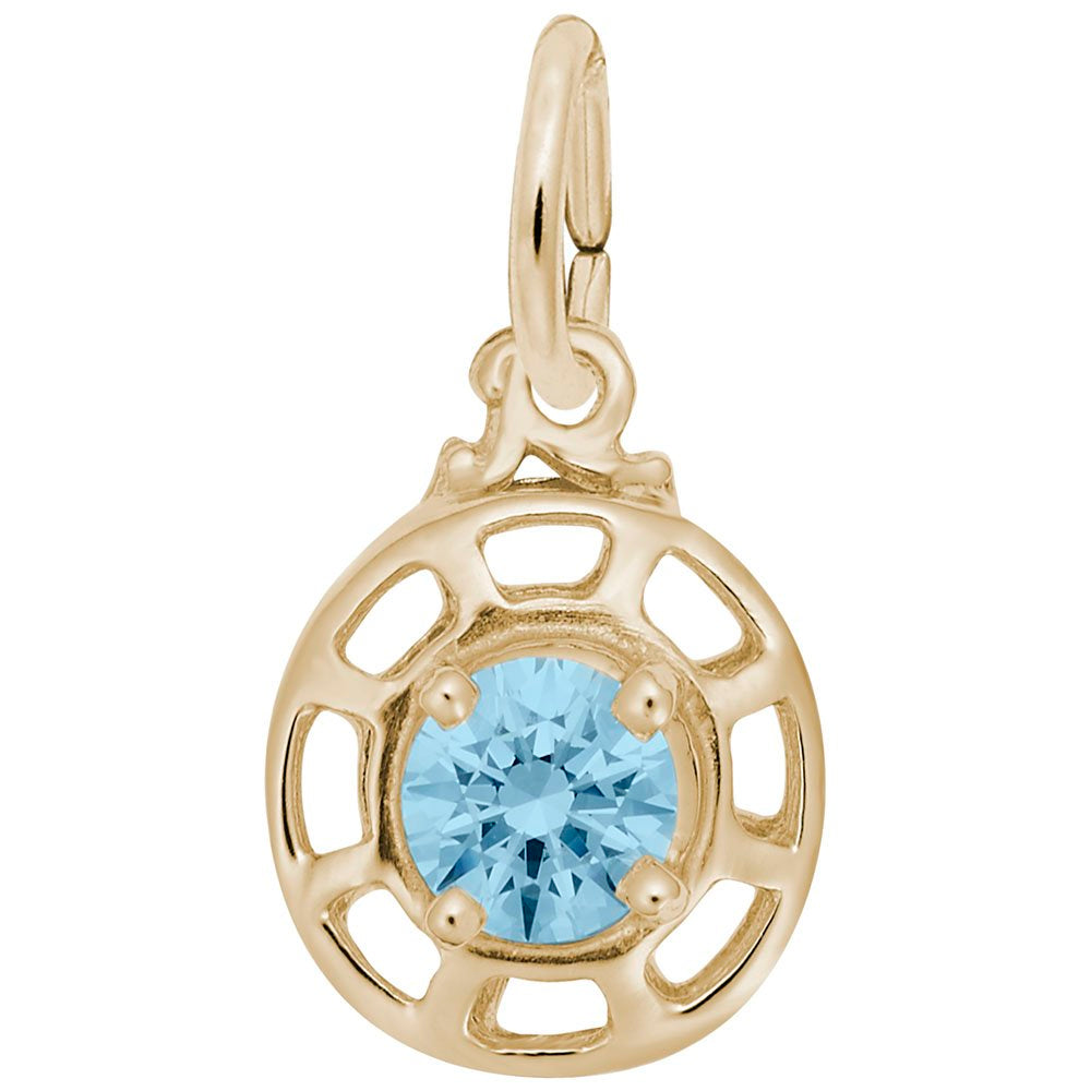 Gold charm with a light blue gemstone on a white background