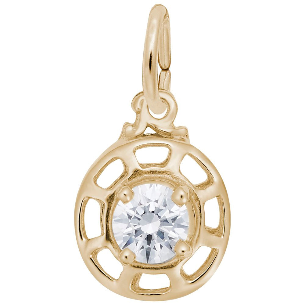 Gold charm with a clear gemstone on a white background