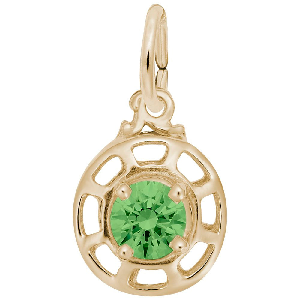 Gold charm with a light green gemstone on a white background