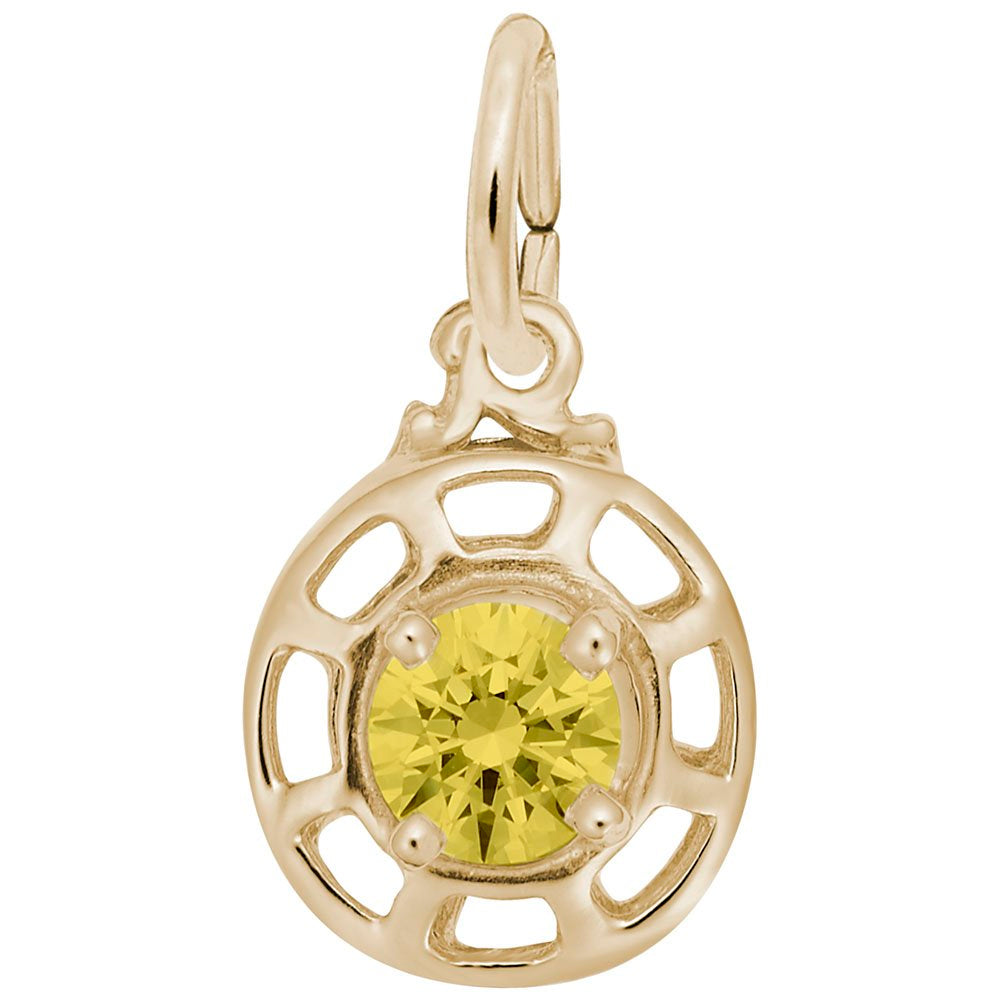 Gold charm with a yellow gemstone on a white background