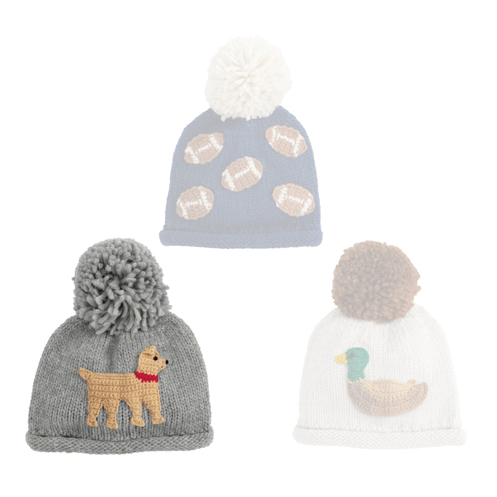 Grey dog knit hat with grey pom-pom on a white background.