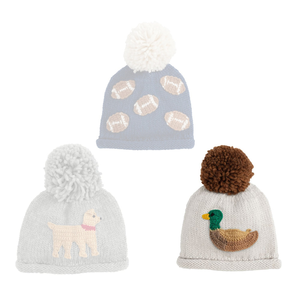 White duck  knit hat with brown pom-pom on a white background.