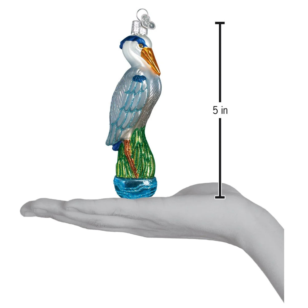 Decorative heron ornament on a hand with a measurement indicator showing 5 inches.