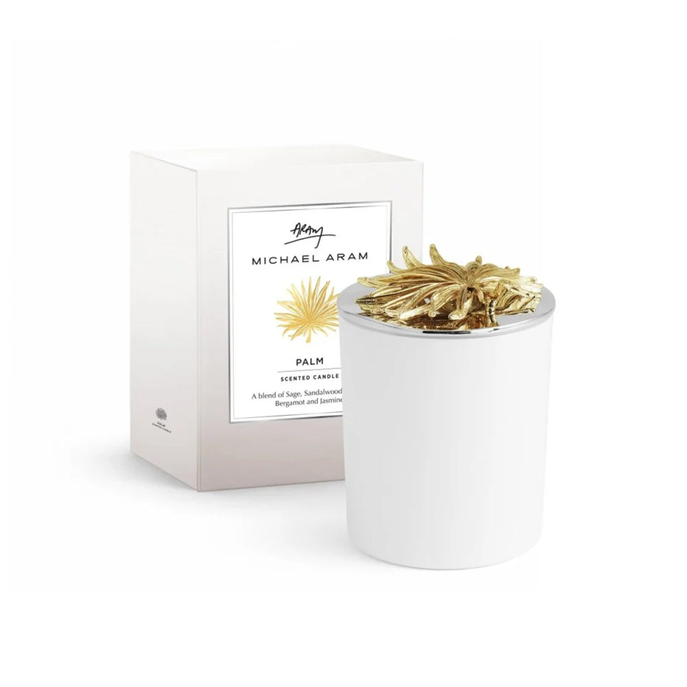 White candle with gold decorative elements next to its packaging on a white background