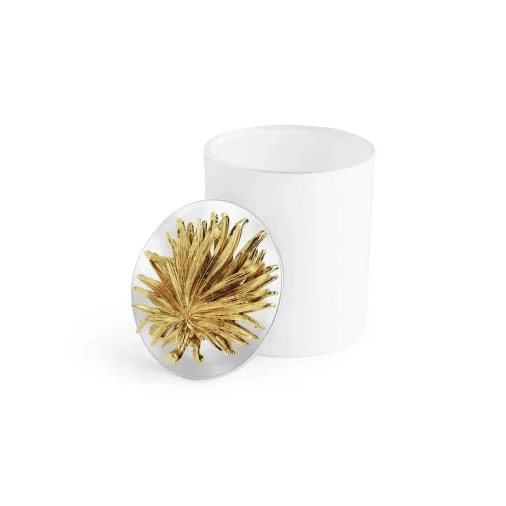 Round white object with gold leaf design on a white background