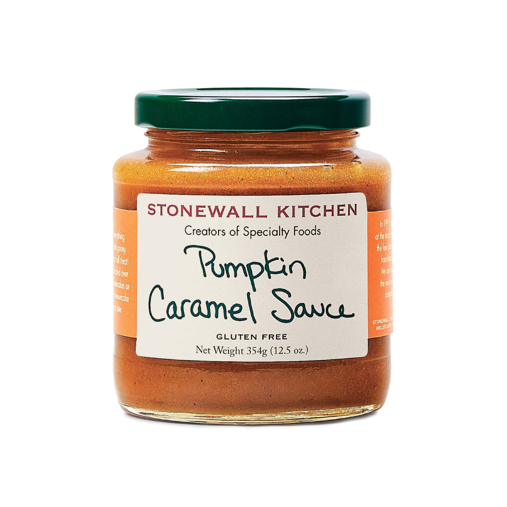 A glass jar of Stonewall Kitchen Pumpkin Caramel Sauce with a dark green lid and a white label, shown on a plain white background.