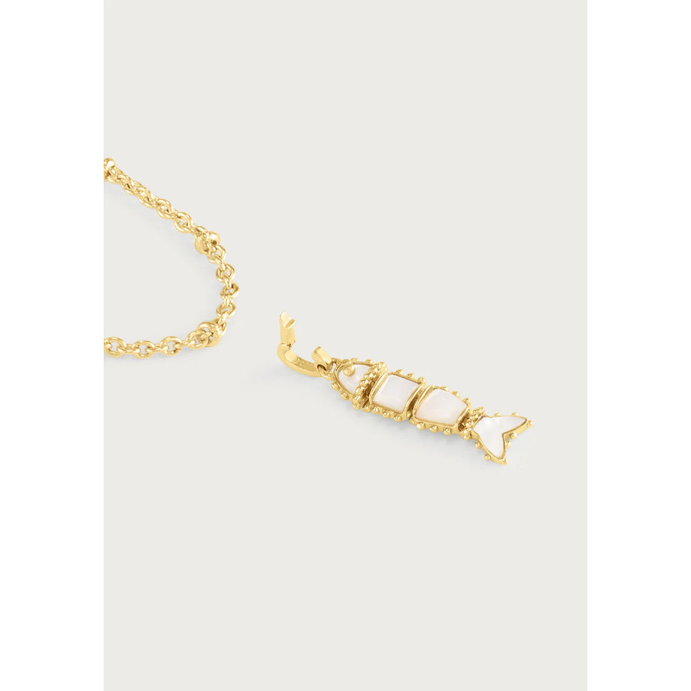 A gold chain necklace with a dangling fish-shaped charm featuring three white inlay stones, shown on a light gray background.