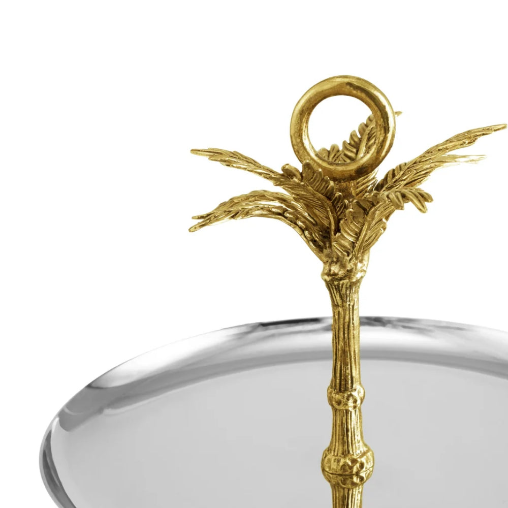 Decorative gold palm tree with a ring on a clear glass dish