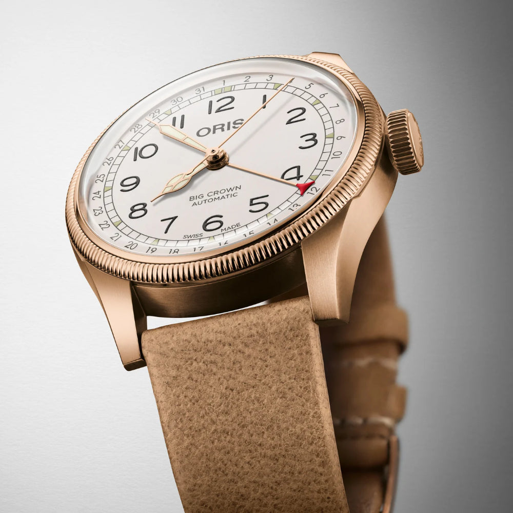 Oris watch with brown leather strap on a gray background