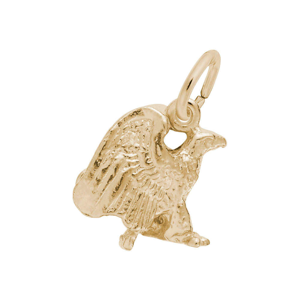 Gold eagle charm on a white background