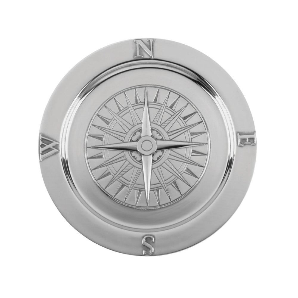 A round, aluminum serving tray with a compass design in the center and directional letters at the sides.