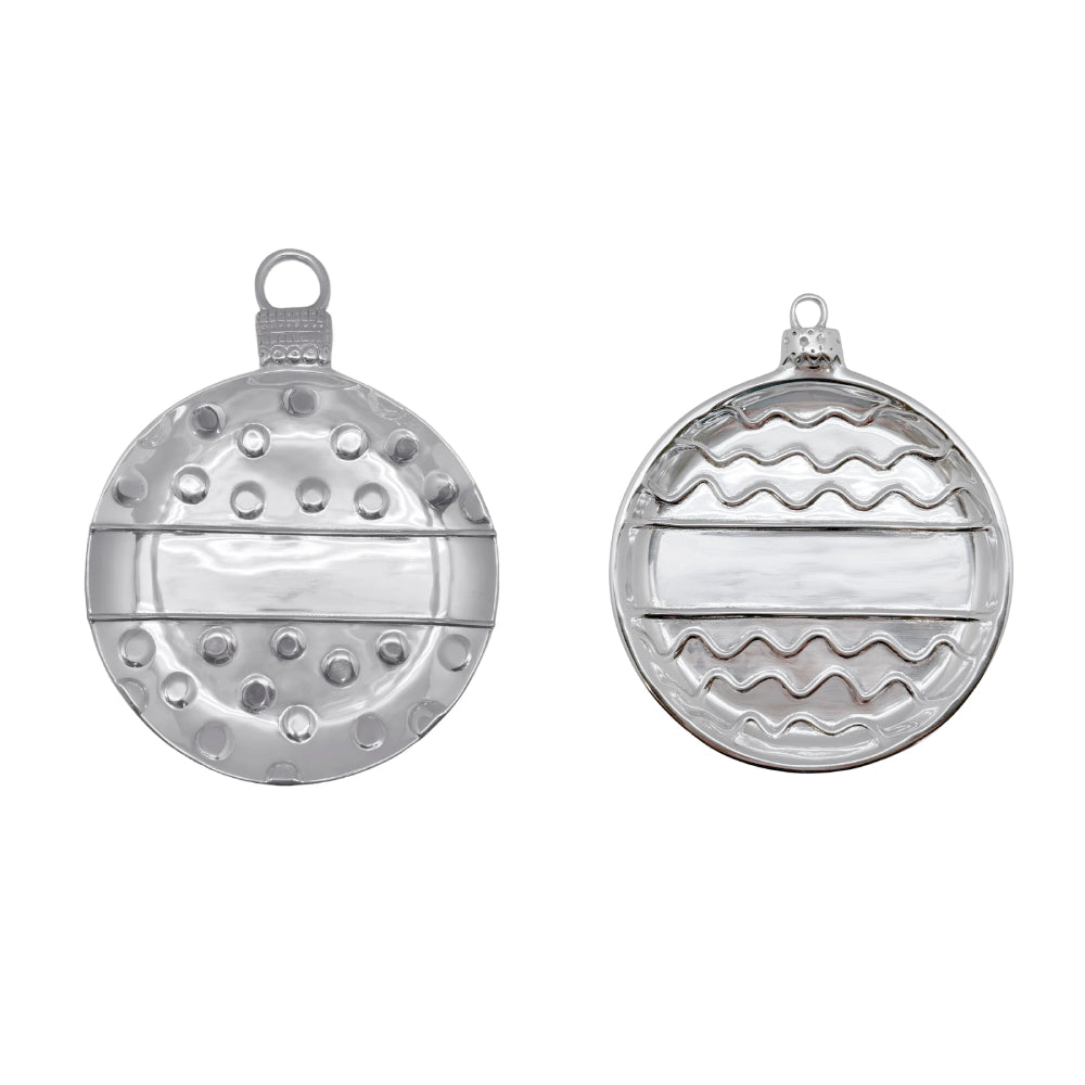 Two round silver Christmas ornament shaped plates shown side by side on a white background, one with a hammered texture and one with a wavy pattern.