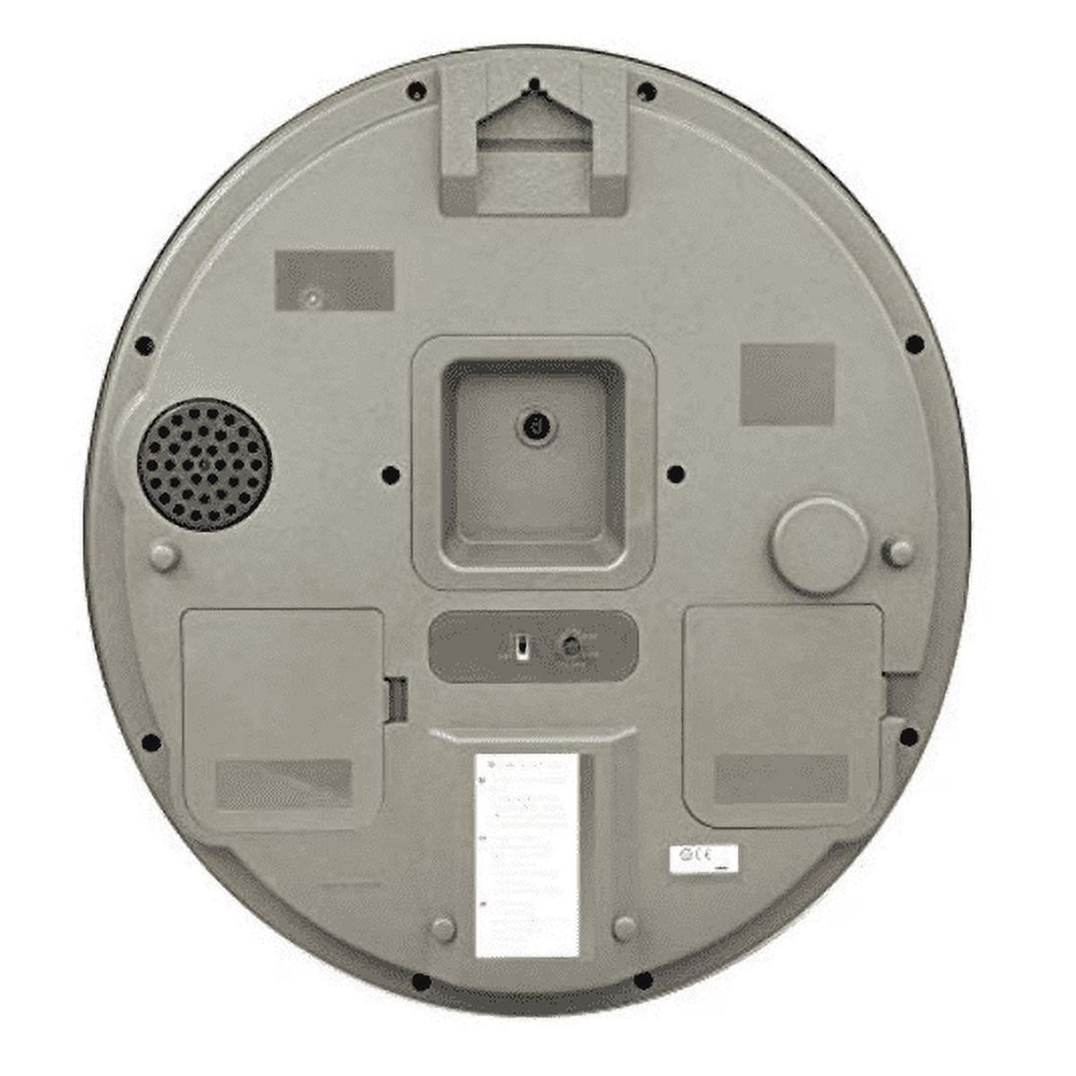 The underside of a circular gray robotic device, showing mounting holes, a speaker grille, a small circular dial, and a white instruction label, on a plain white background.