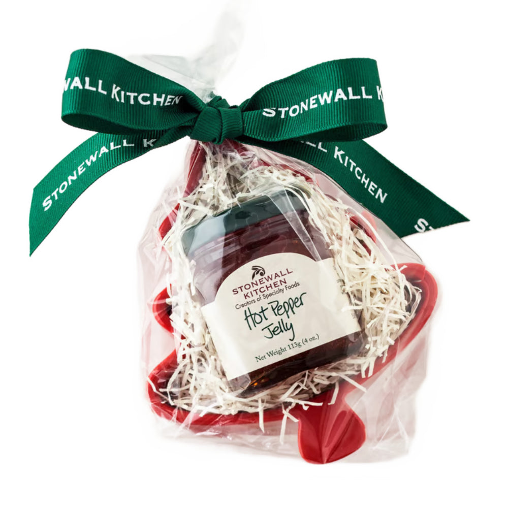 Red tree ramekin with green ribbon and Stonewall Kitchen hot pepper jelly jar in clear gift wrap and green ribbon on a white background.