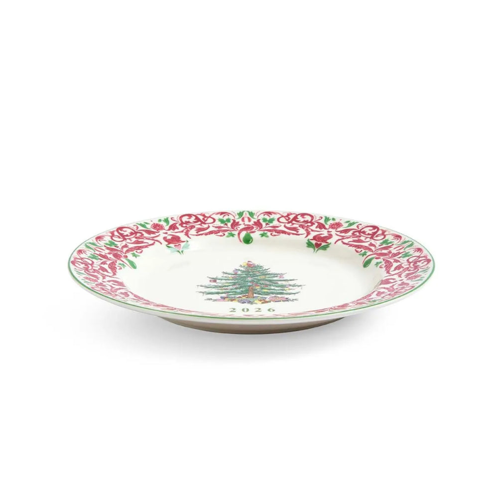 A white ceramic Christmas plate featuring a red and green floral border and a green Christmas tree illustration with the year '2026' printed below it, shown on a clean white background.
