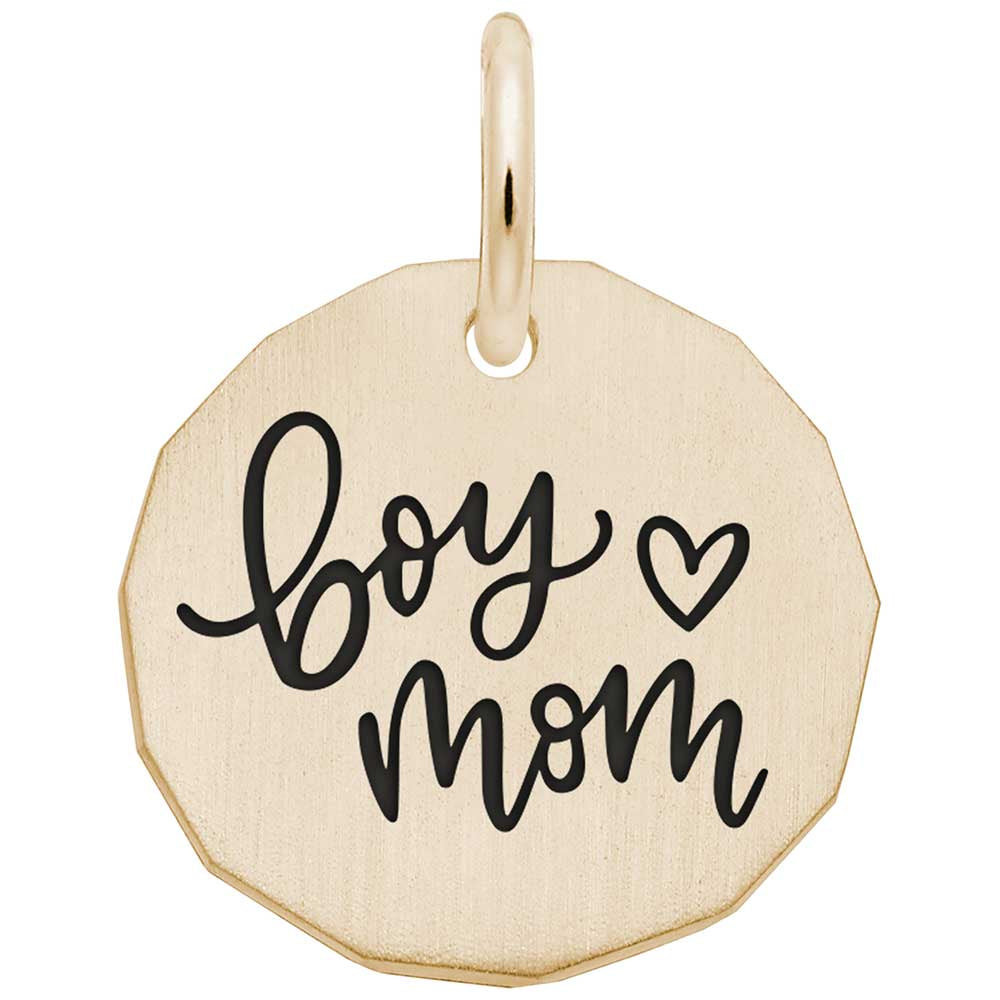 Gold pendant with 'boy mom' written on it on a white background