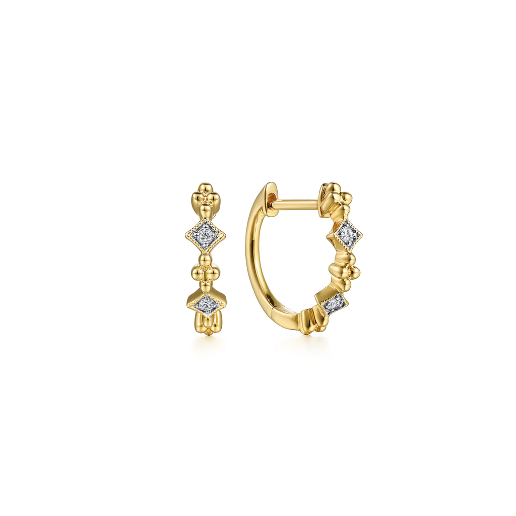 Gold hoop earrings with diamond accents on a white background