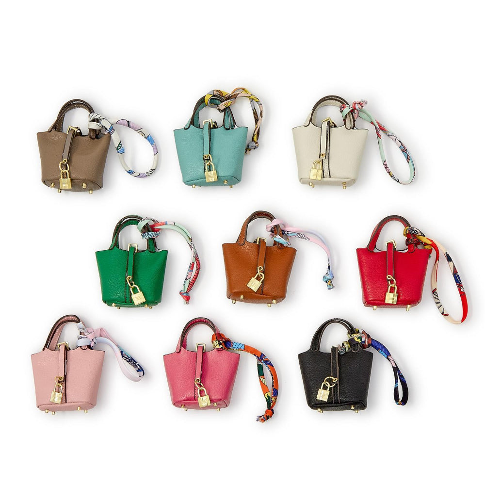 8 colorful mini handbags keychains with matching straps on a white background