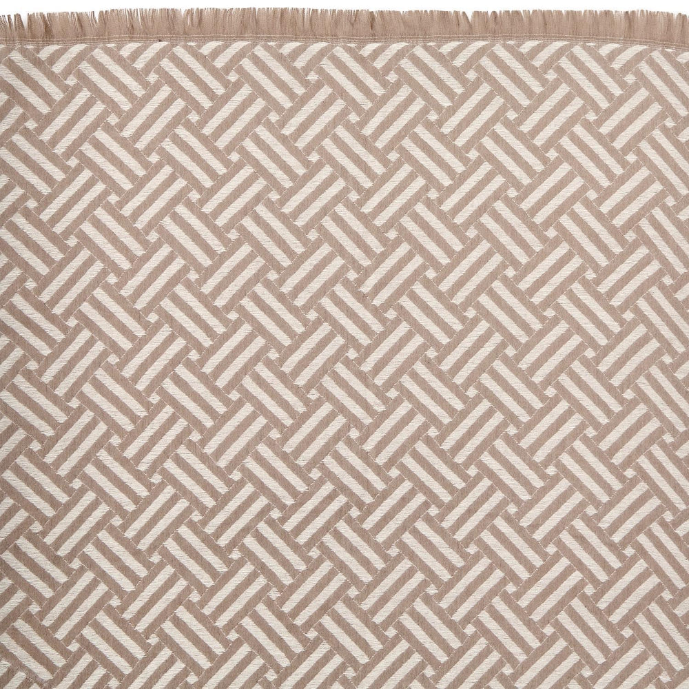Close-up of a beige  & white patterned scarf in a geometric design 