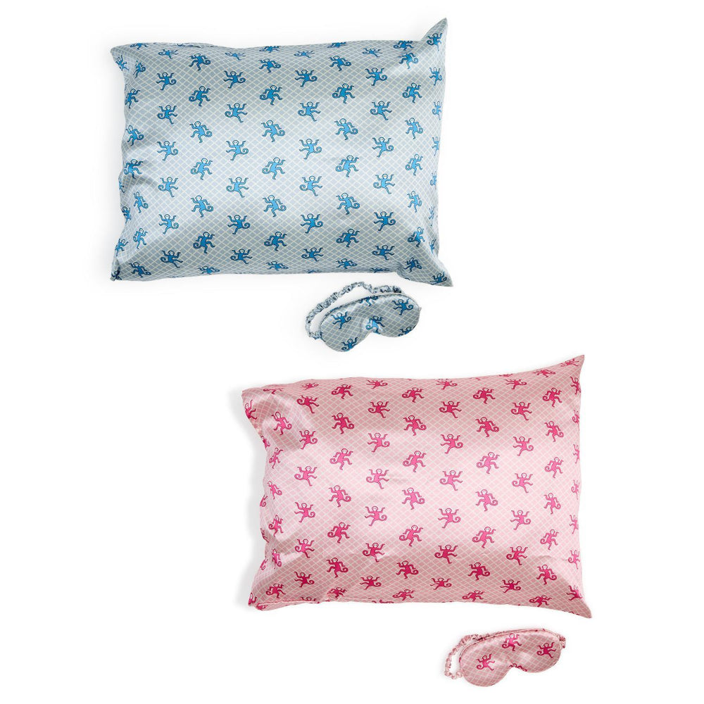 Two pillowcases with butterfly patterns and matching sleep masks on a white background