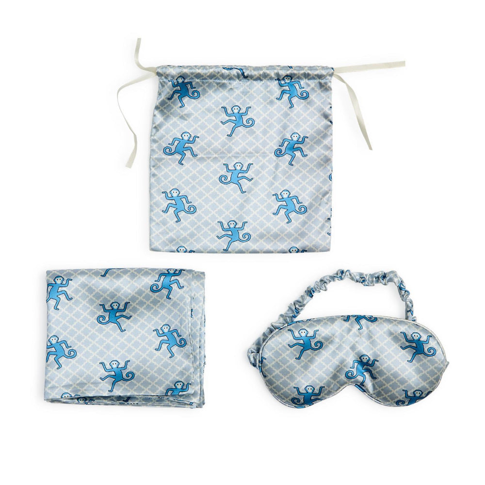 Set of eye mask and pillowcase with blue monkey pattern on a white background